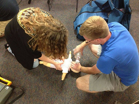 Lady Holding The Doll While Man Holding Oxygen